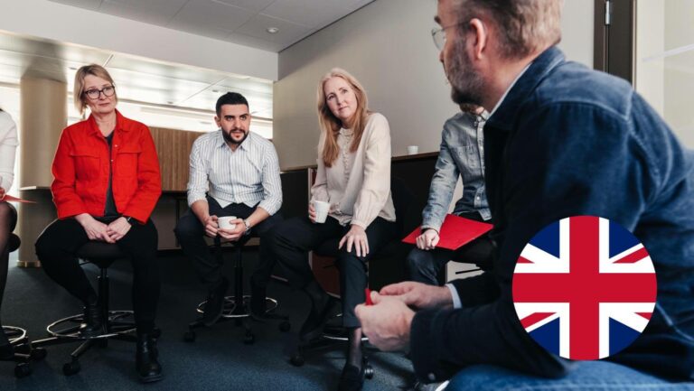 A group of people conversing in a training session.